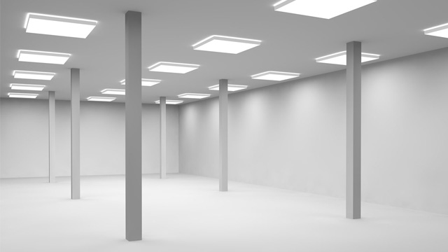 Empty a large room lit by lamps for office or shop.